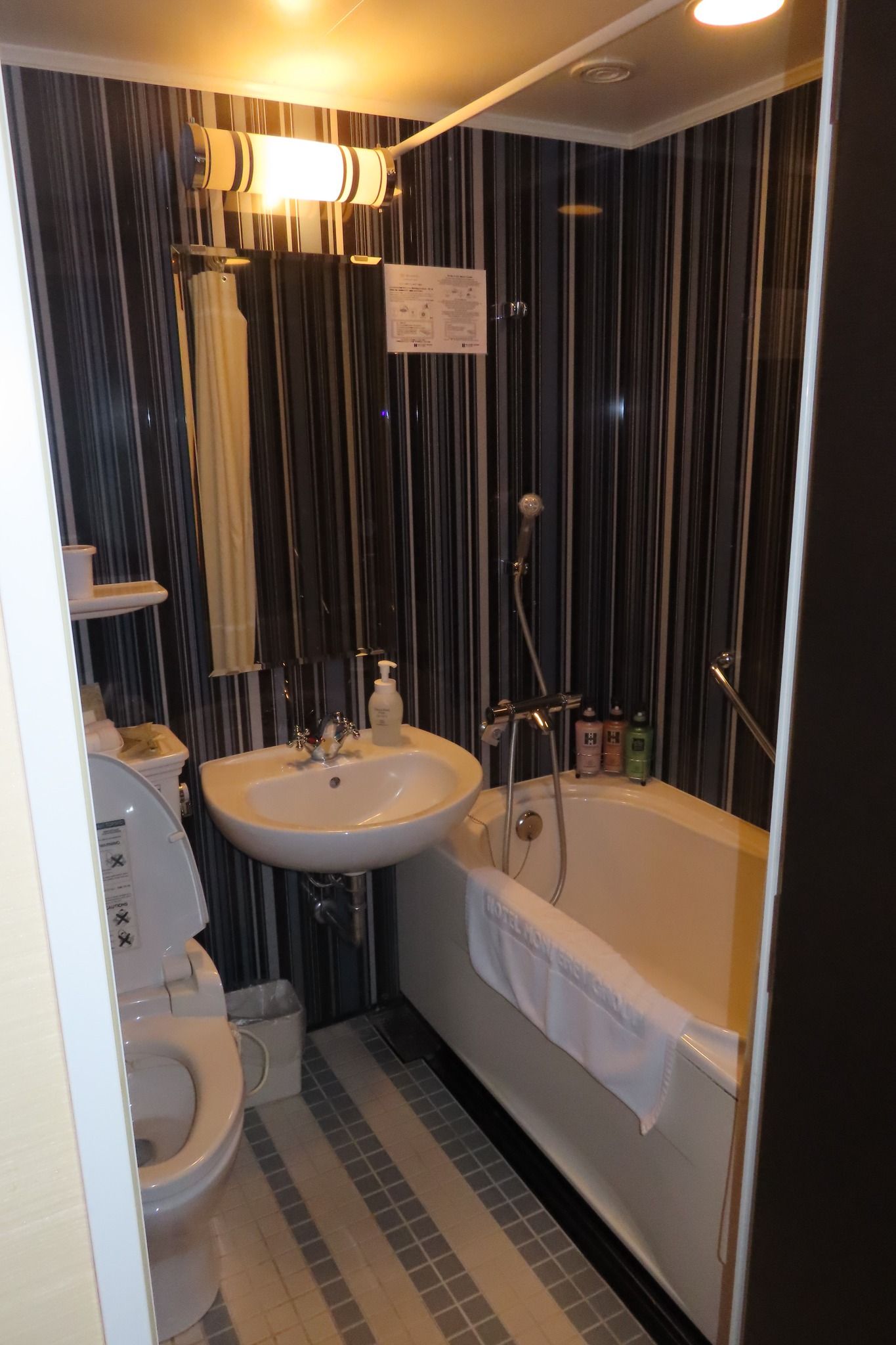 A bathroom with a sink , toilet , bathtub and shower.