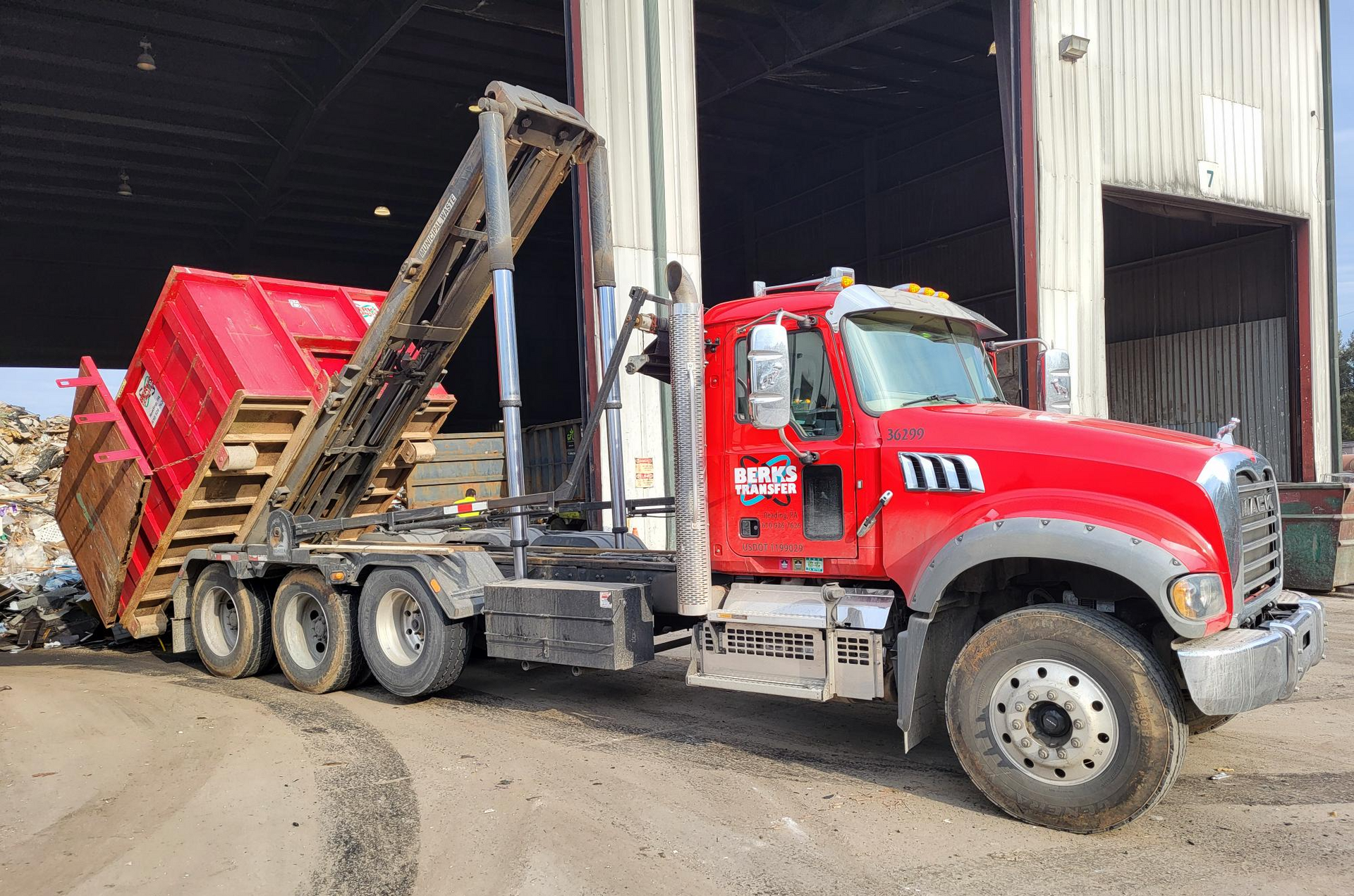 A large red dumpster that says Berks on it.