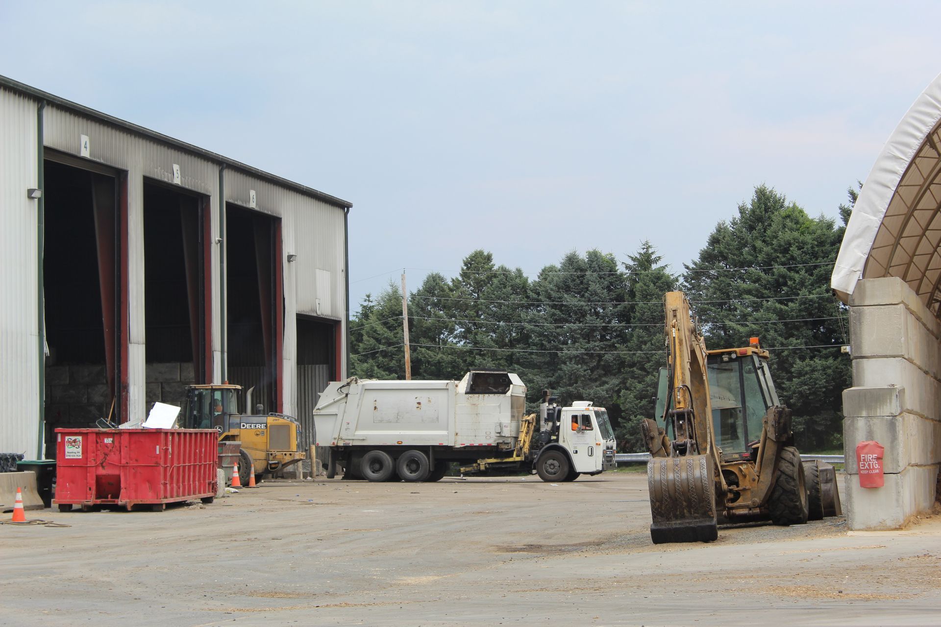 A white municipal garbage truck unloads at Berks Transfer.