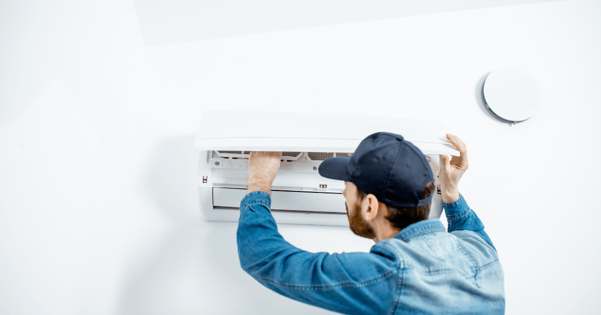 Picture of a man repairing an HVAC unit