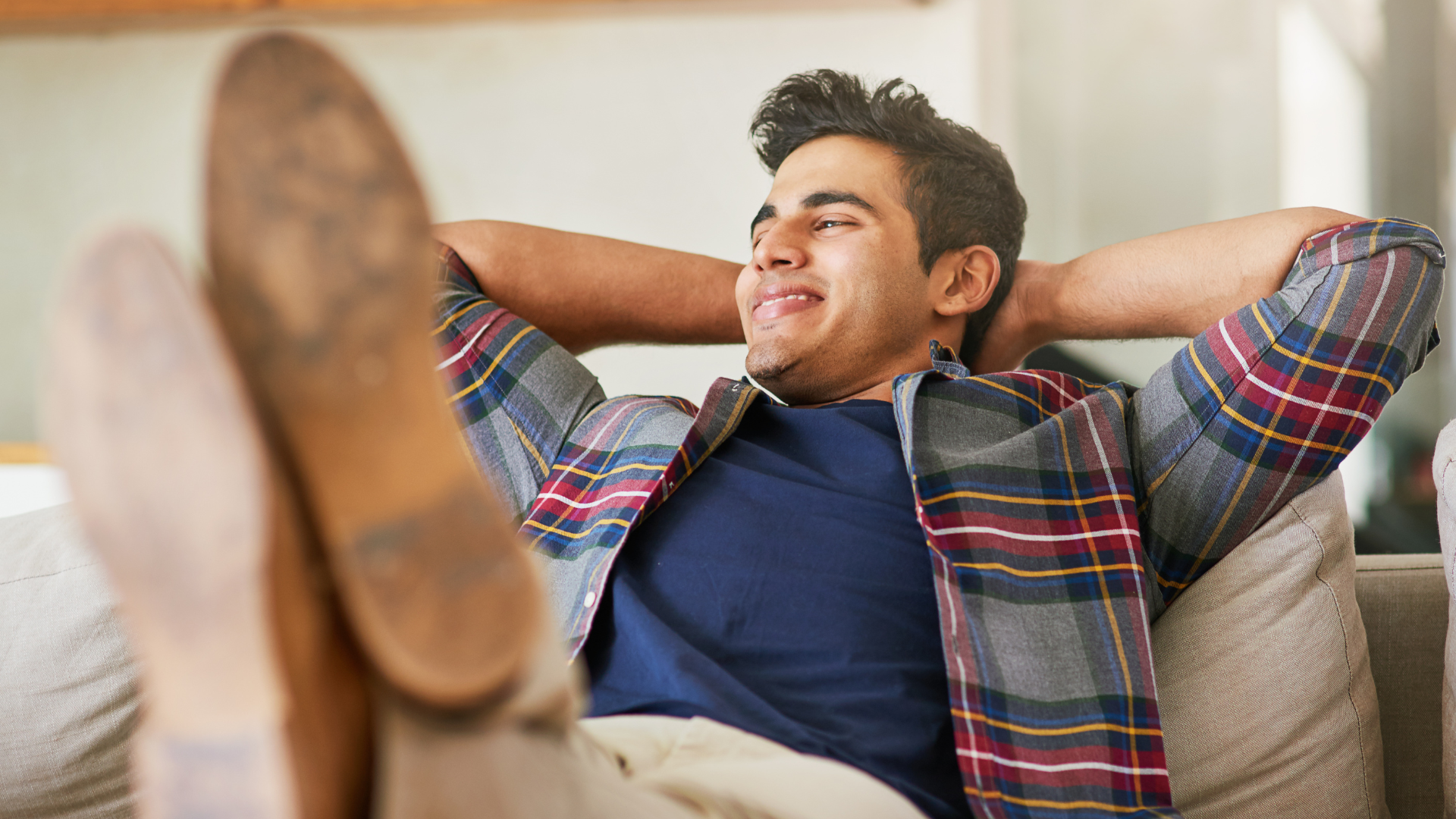 picture of a man sitting in the couch enjoying the comfort