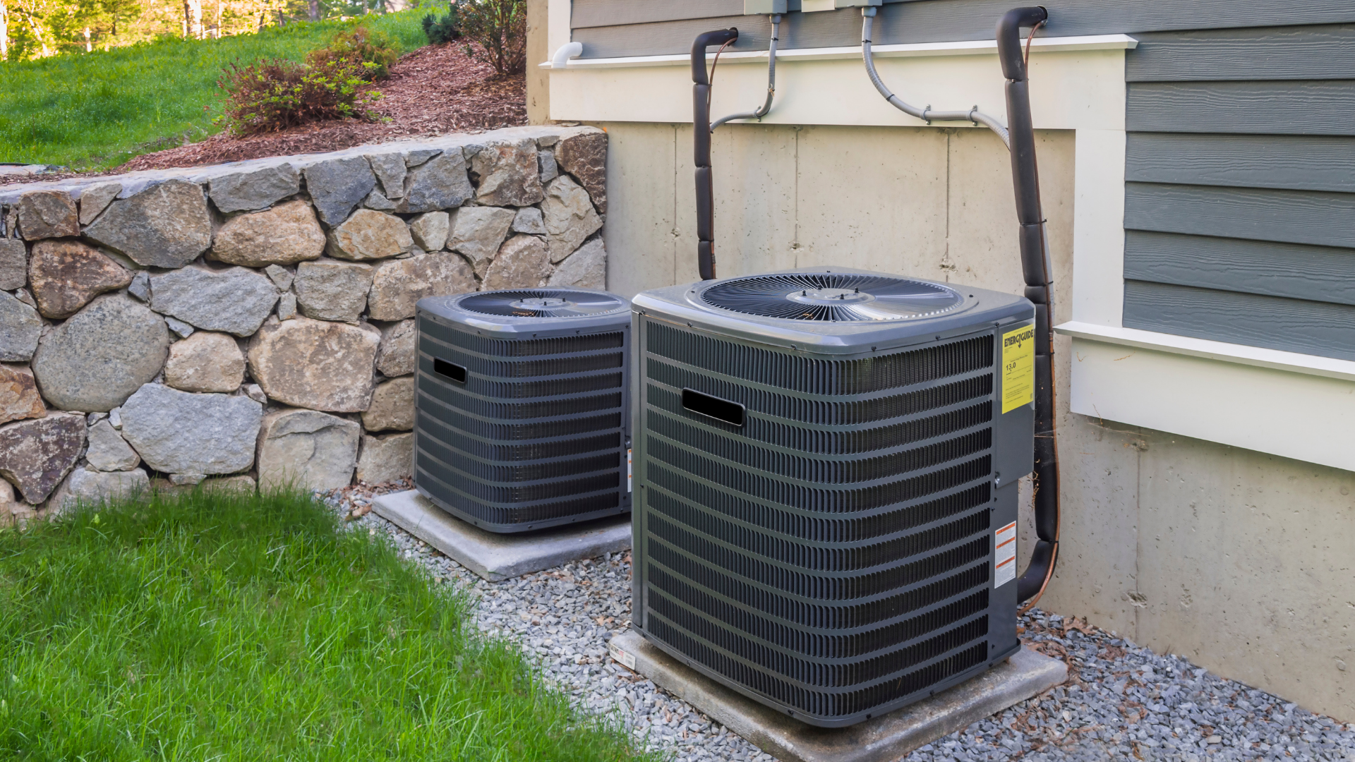 Picture of two AC units outside of a building.