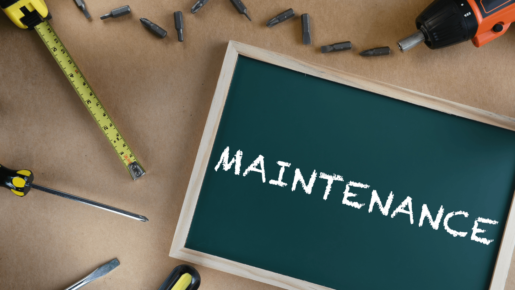 Picture of tools with a chalk board that has the word maintenance on it.