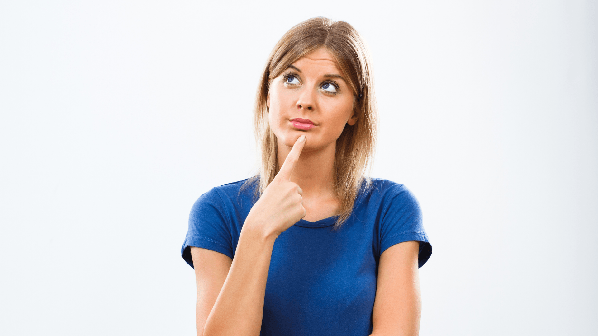 Woman in a blue shirt with a thoughtful expression.