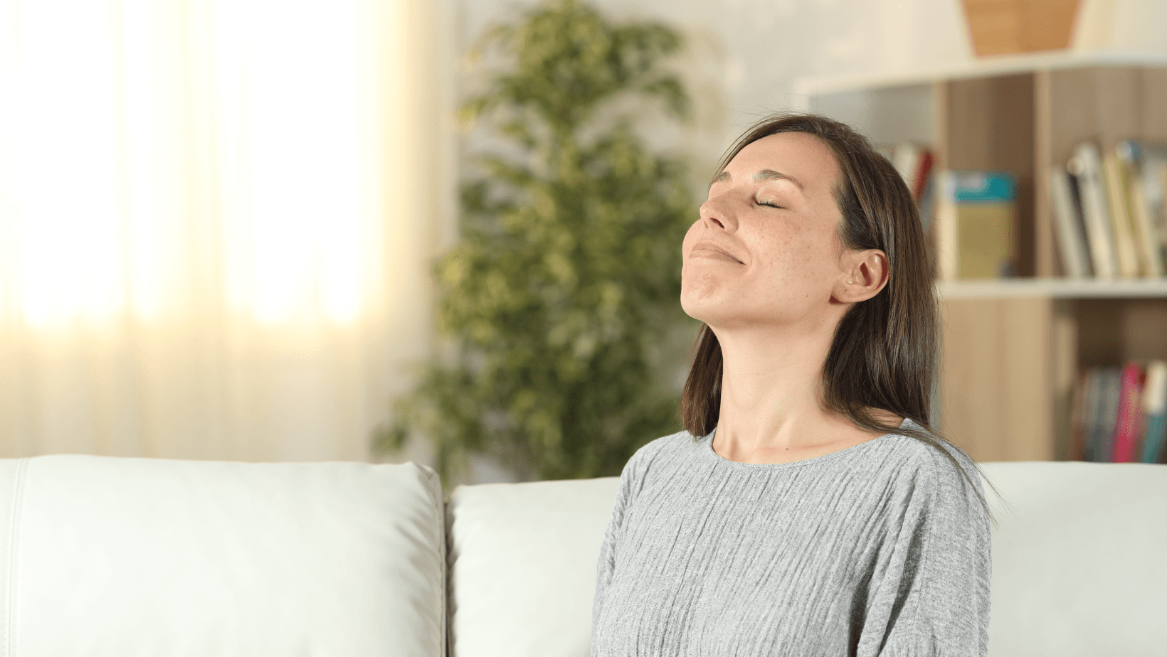 Picture of a woman inhaling and looking calm.