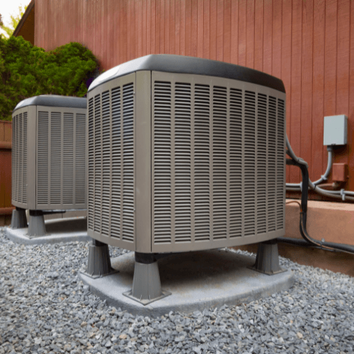 Two Heat Pumps outside of a building.