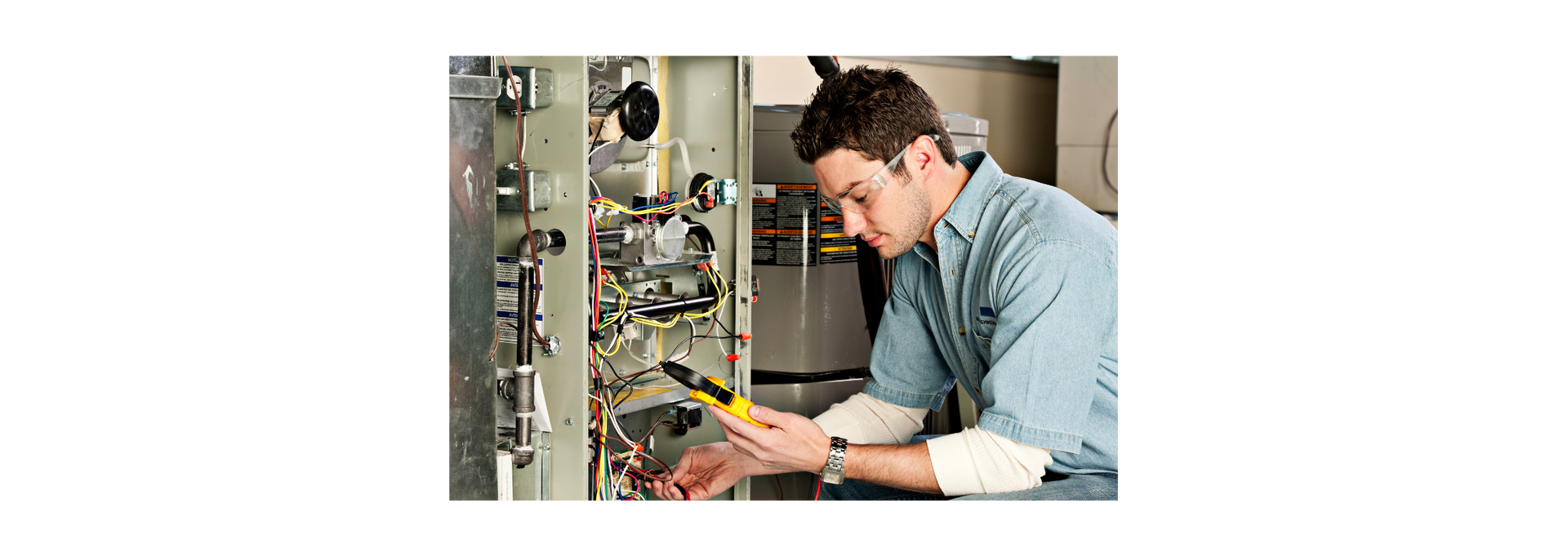 Image of a person checking the furnace