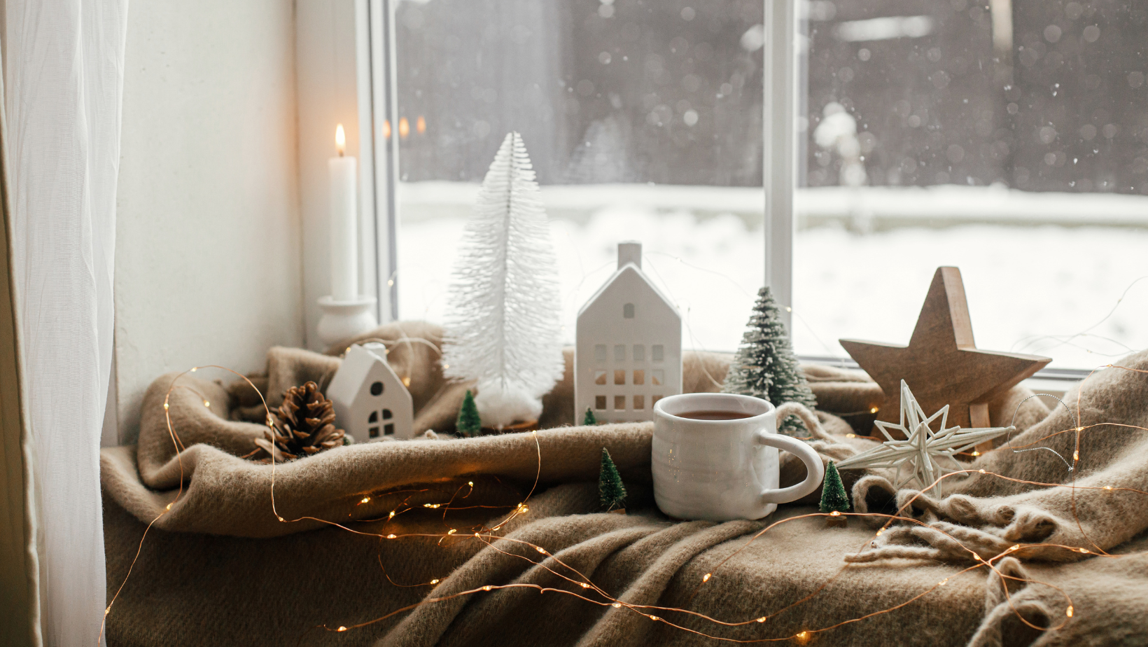 Windowsill with Christmas decorations and fairy lights