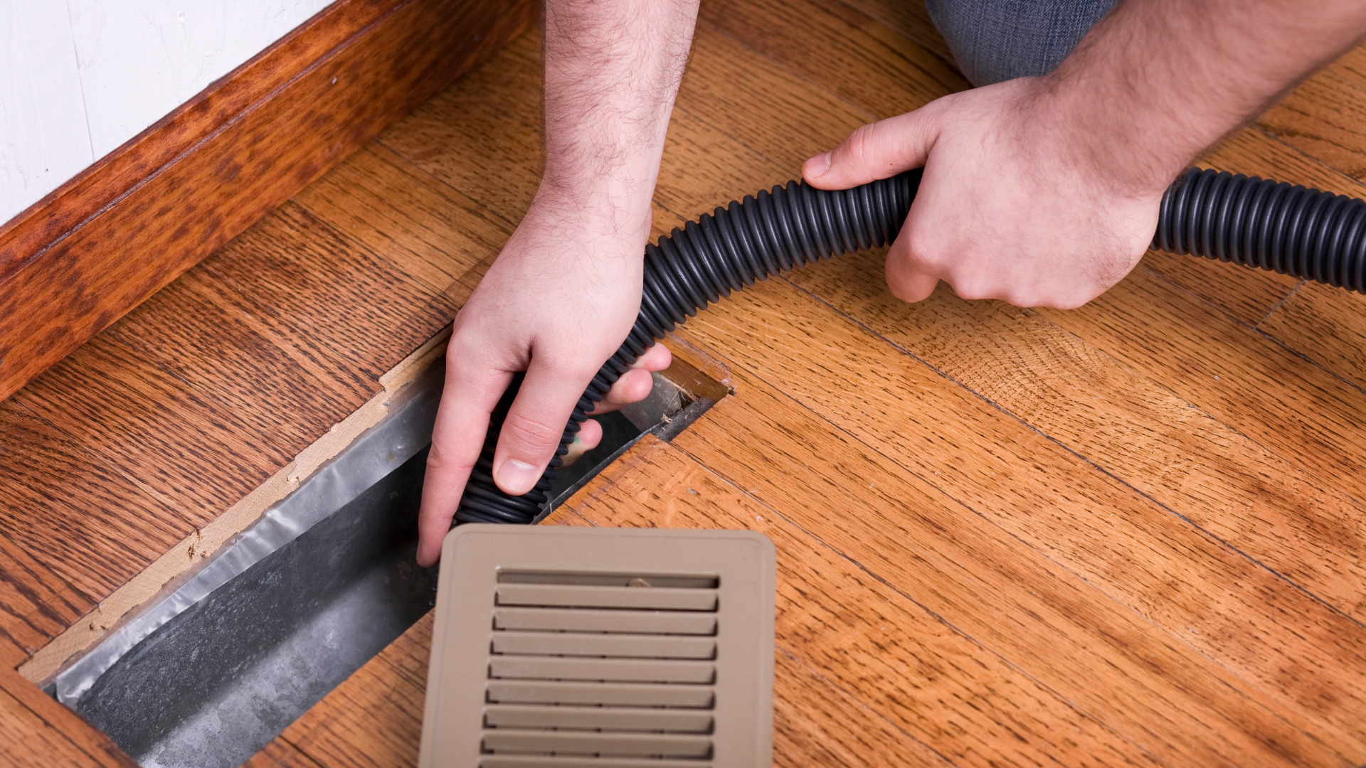 image of a man cleaning the air duct