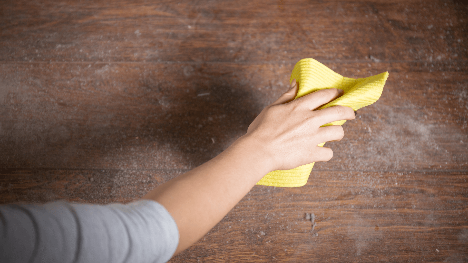 Picture of a hand wiping a dusty surface.