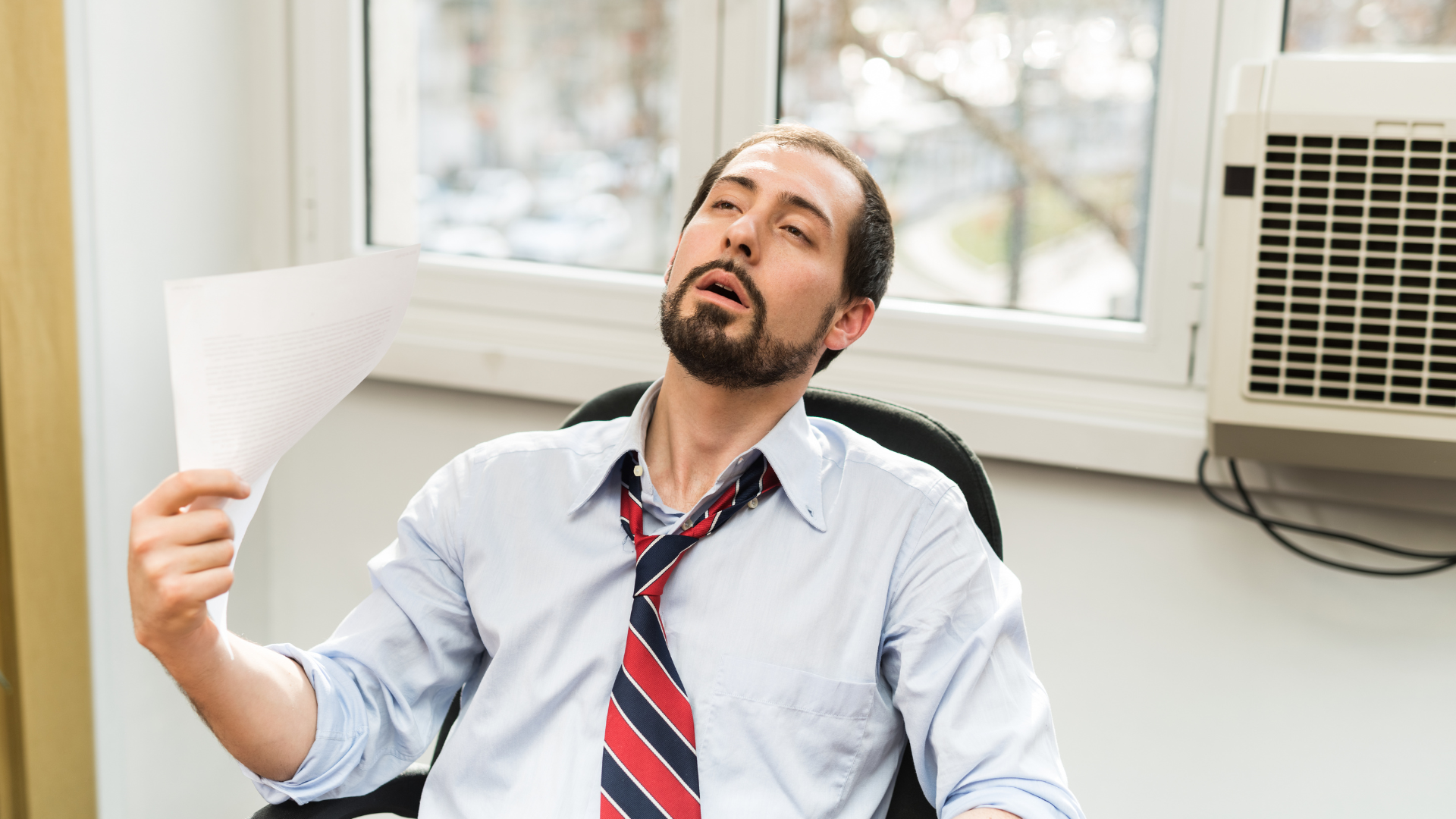 man sitting on the chair feeling hot