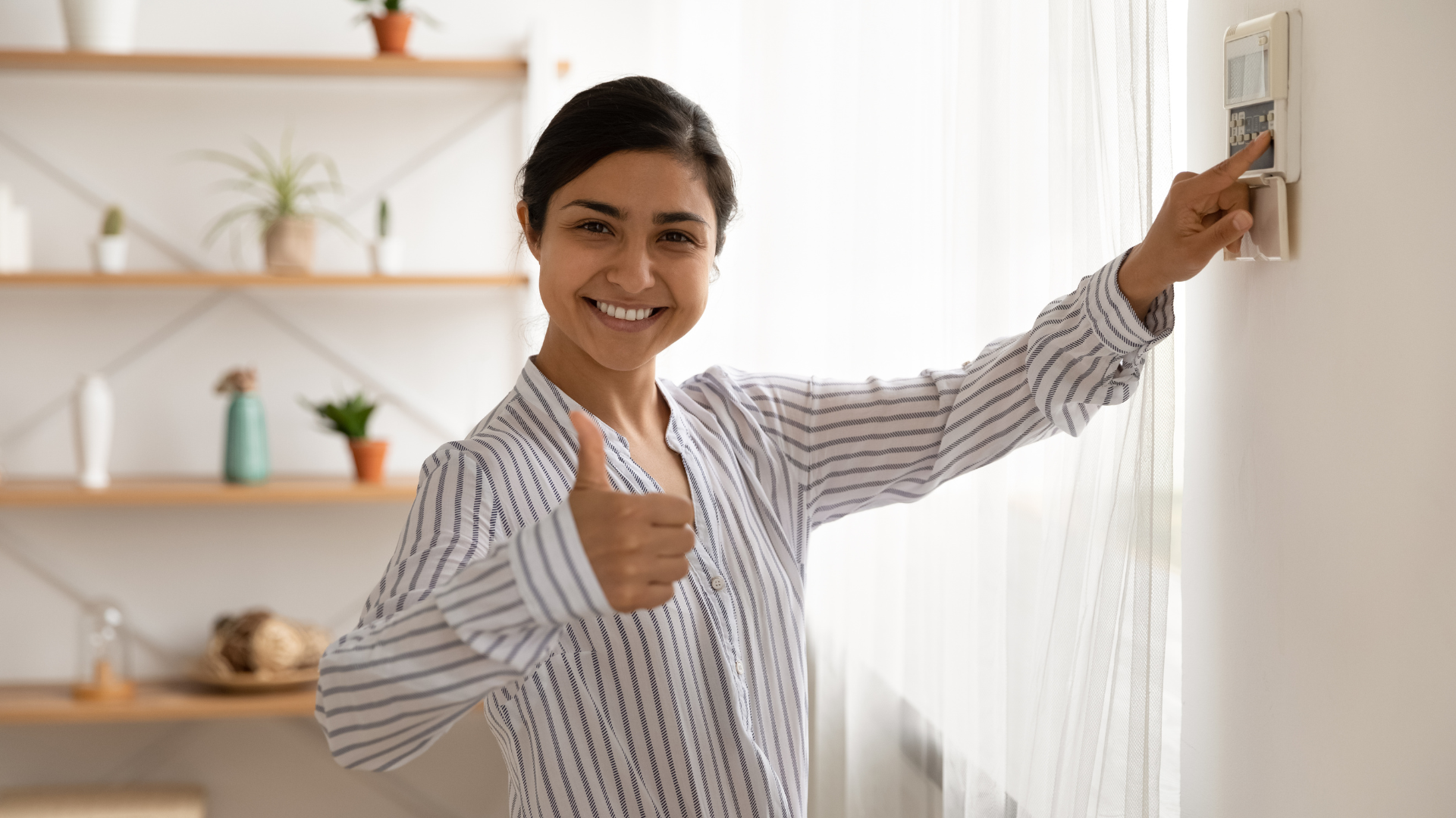 happy woman clicking the thermostat with thumbs up