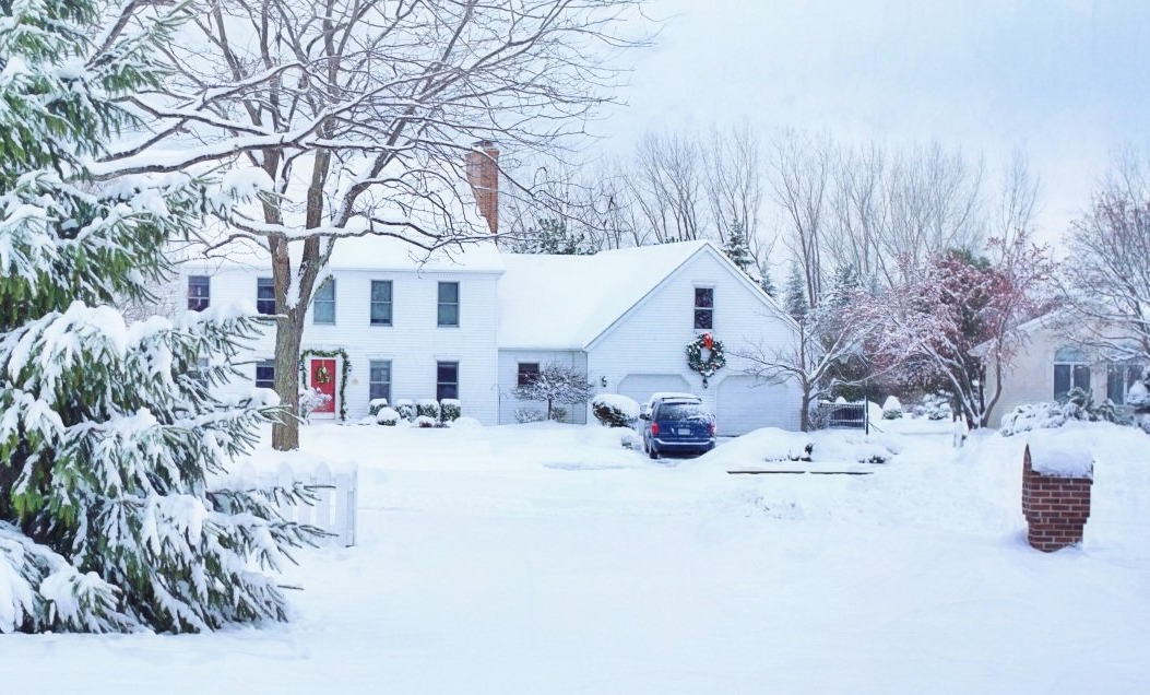 Picture of a house with lots of snow outside.