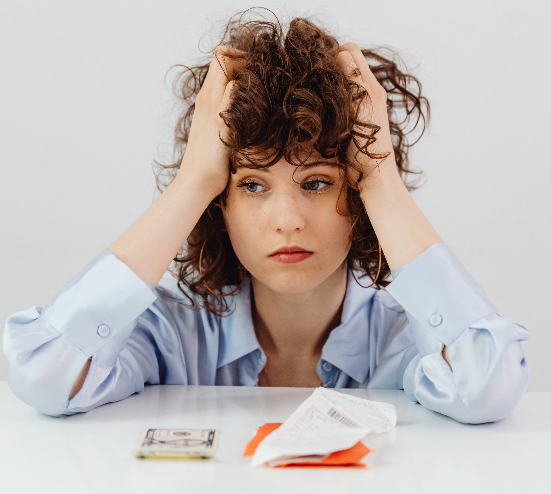 Picture of a woman frustrated paying bills.