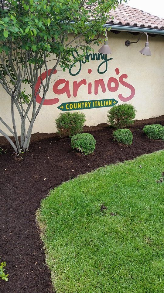 A sign for johnny carino 's country italian restaurant is painted on the side of a building.