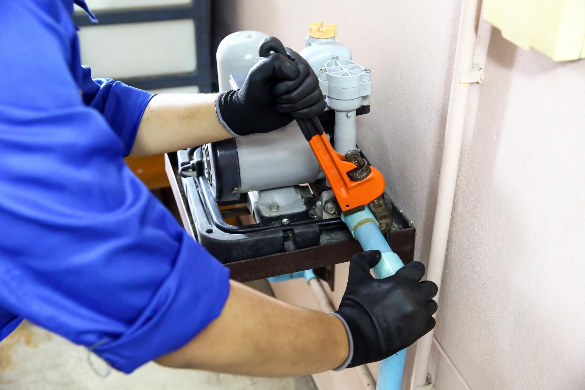 Technician plumber using wrench to repair water.