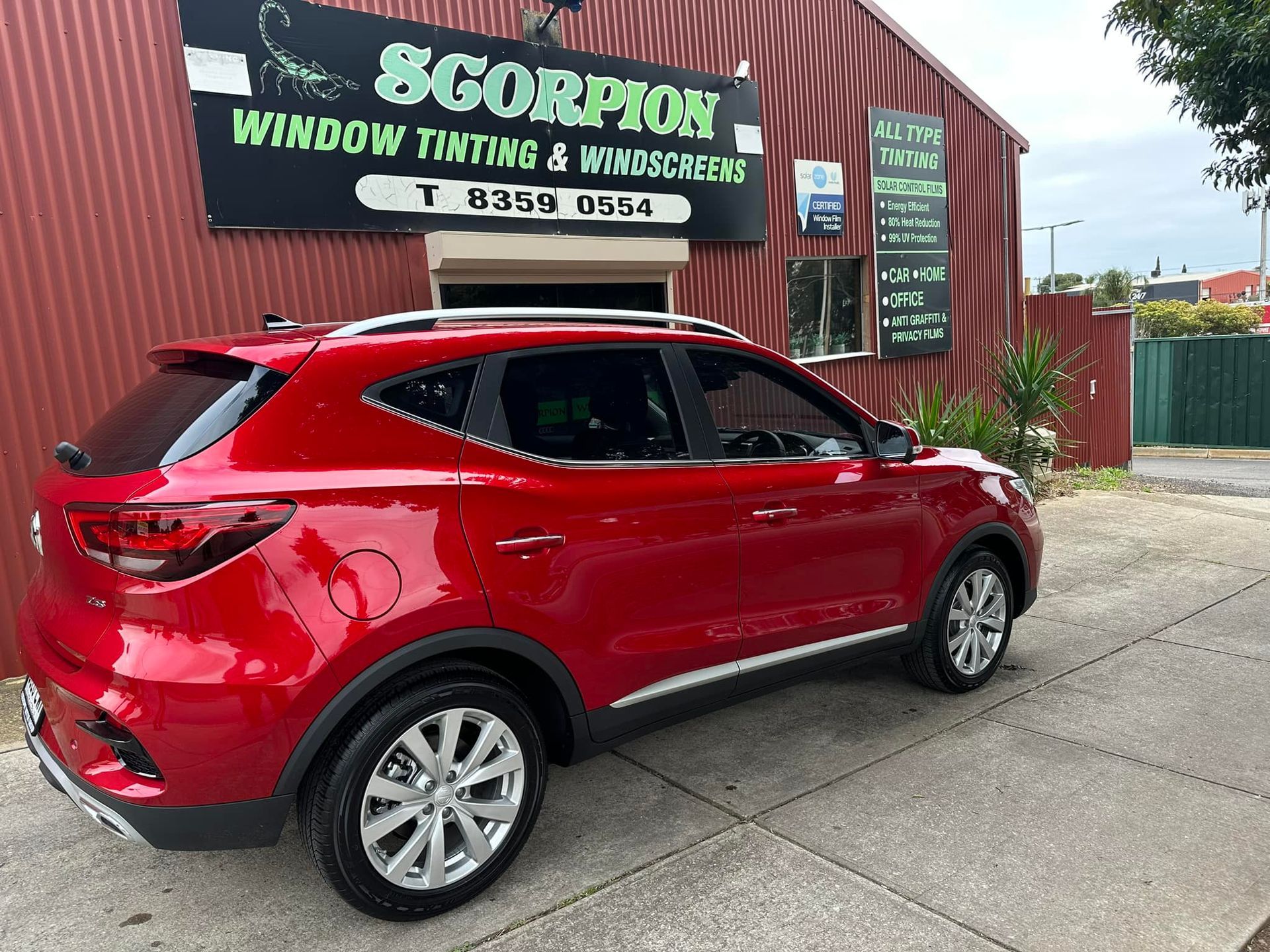 Red SUV in Front of Business Building — Enfield, SA — Scorpion Window Tinting