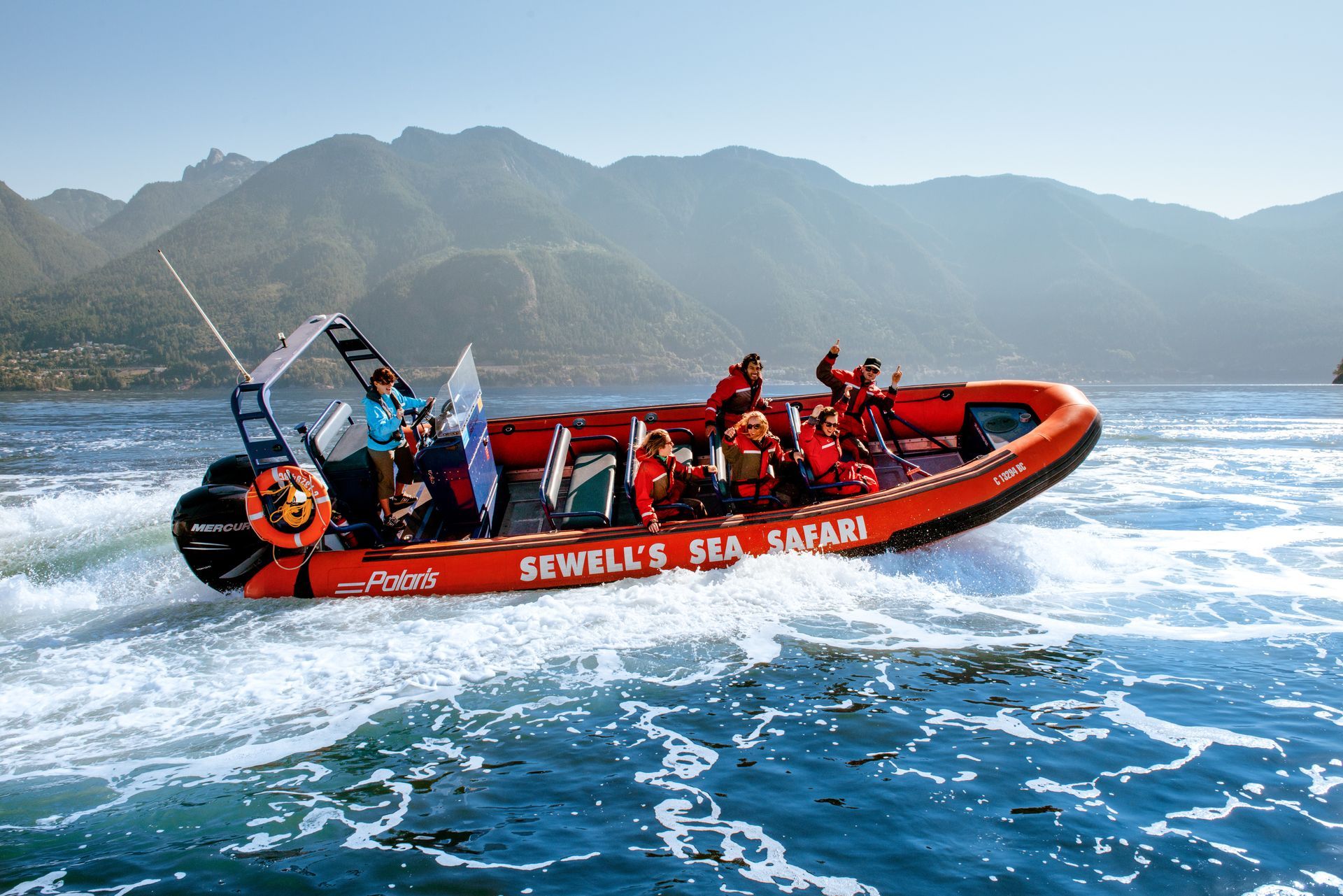 Orange boat with passengers on water, 