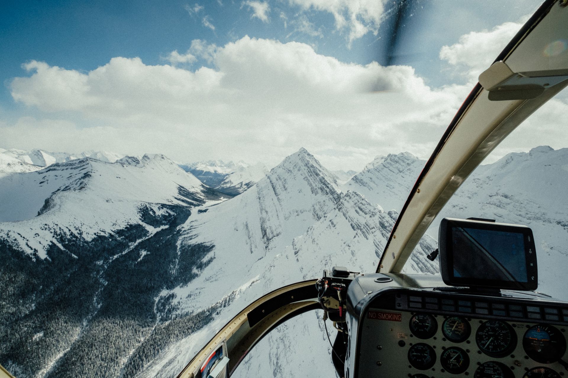 Colorful houses on a hillside overlooking a harbor with a road winding by.