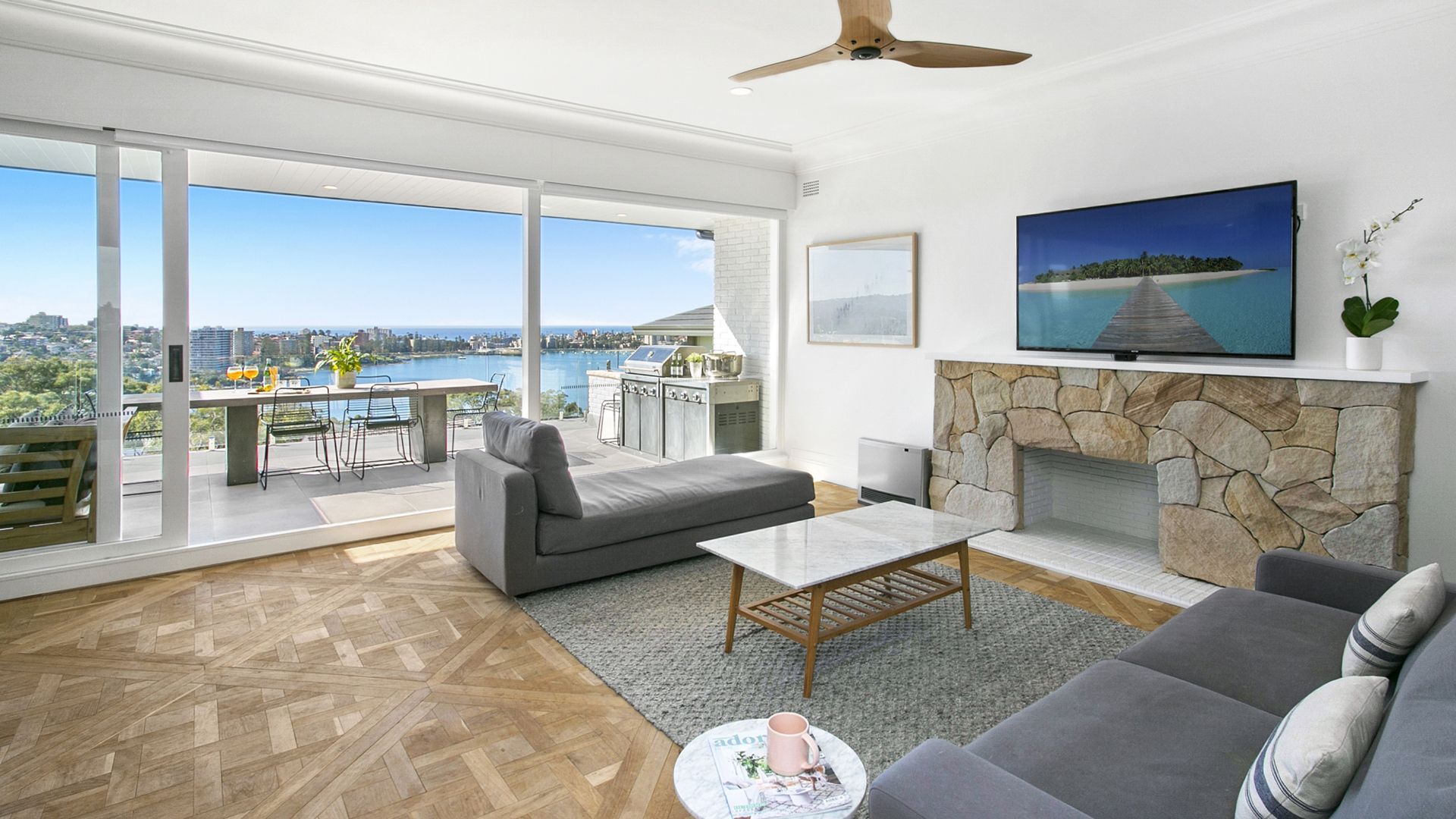 A living room with a couch , fireplace and television.