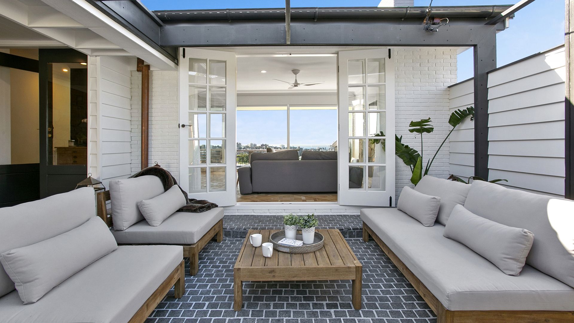 A patio with a lot of furniture and a table