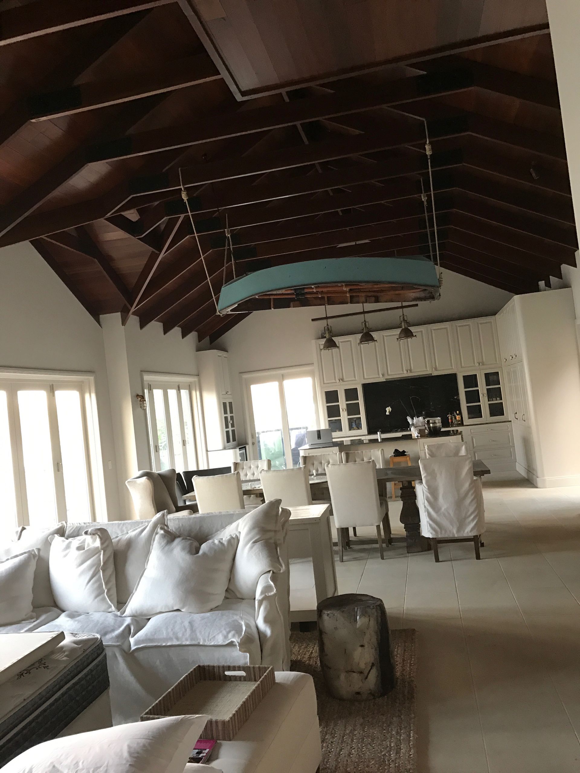 A living room filled with furniture and a wooden ceiling