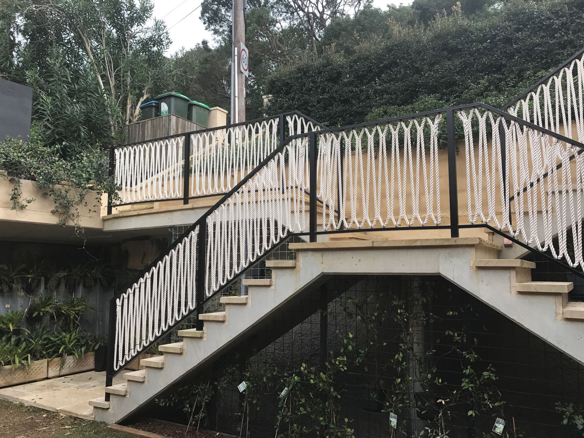 A set of stairs with a black and white railing