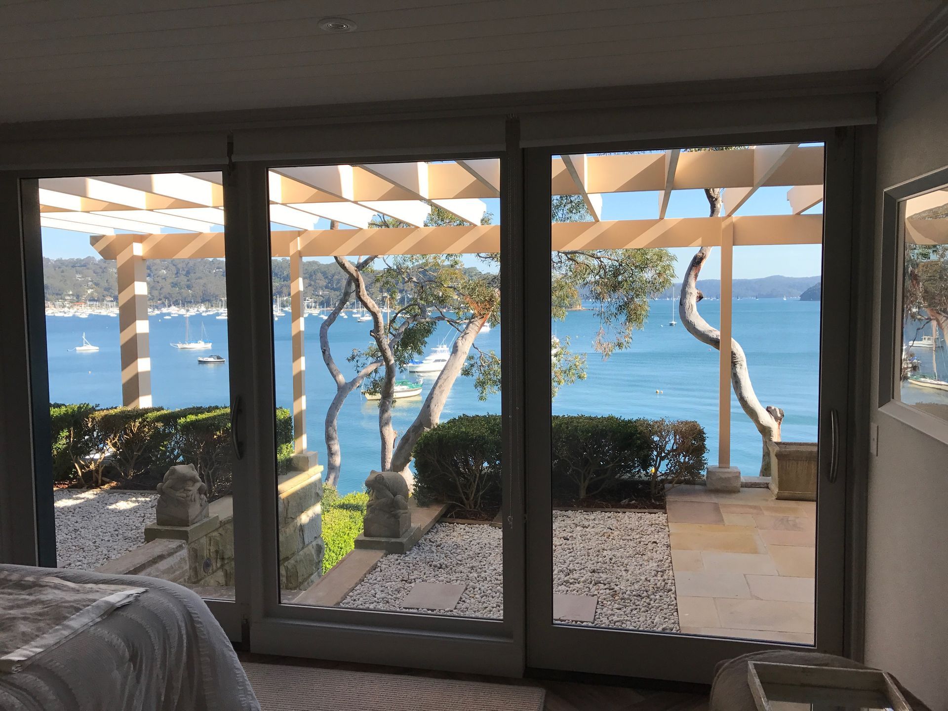A bedroom with a view of the ocean through the windows