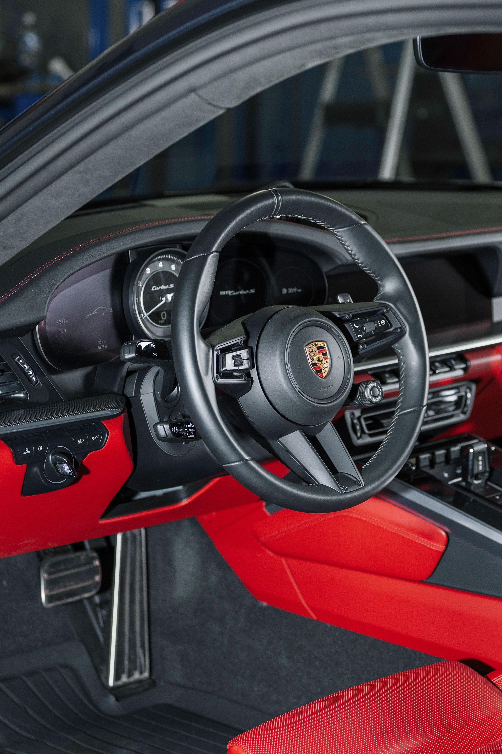 A close up of the steering wheel of a porsche