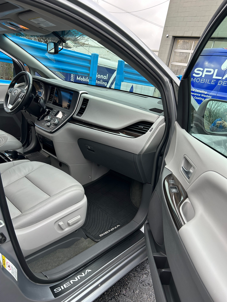 The interior of a toyota sienna is shown with the door open.