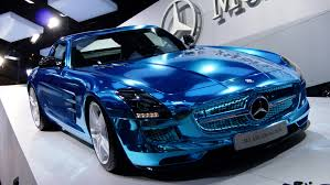 A blue mercedes benz sls is on display at a car show.