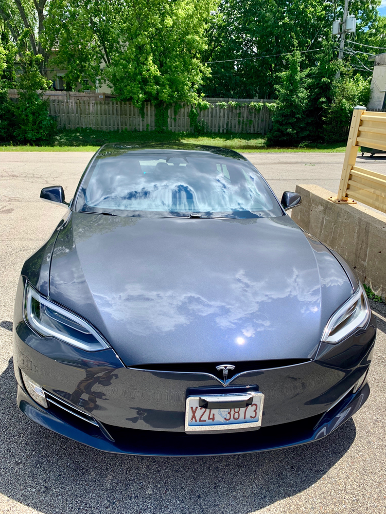 A tesla model s is parked in a parking lot.