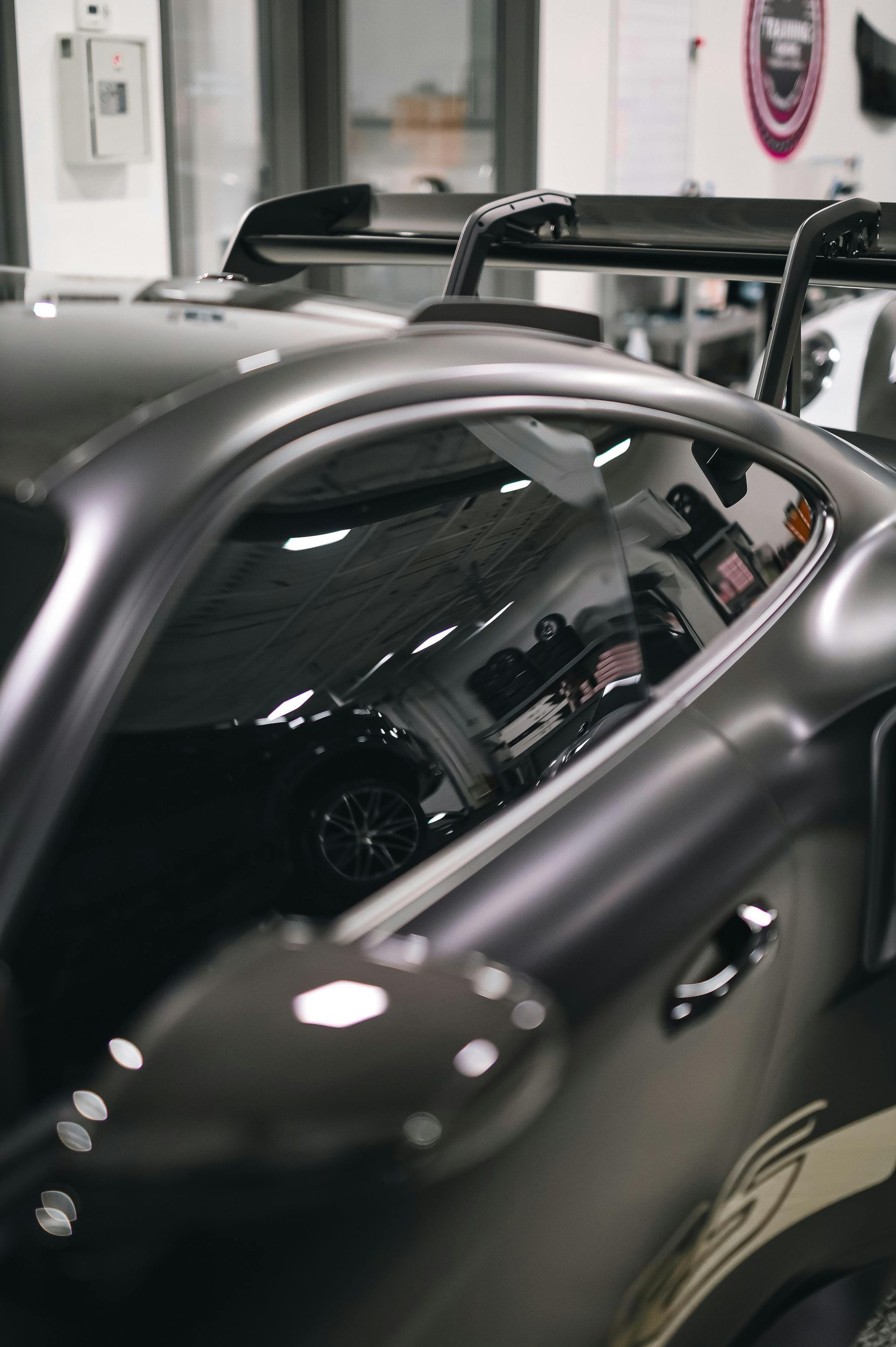 A car with the door open and a black window