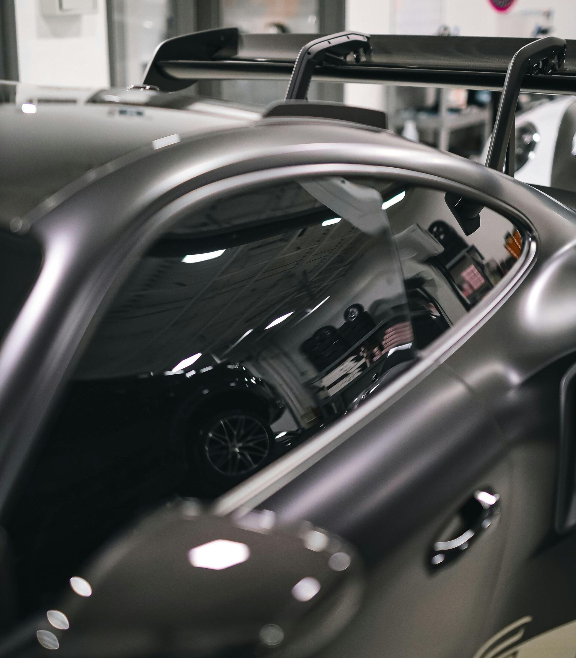 A car is parked in a garage with the door open.