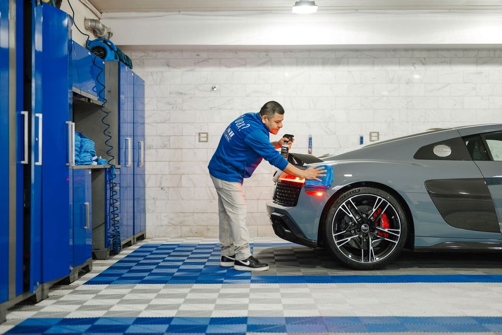 A man is working on a car in a garage.