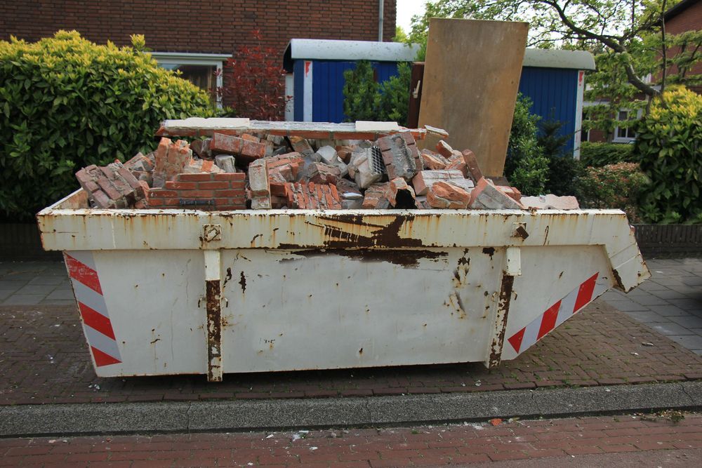 White Dumpster Filled With Construction Debris — Skip Bin Hire Sunshine Coast in Doolan, QLD