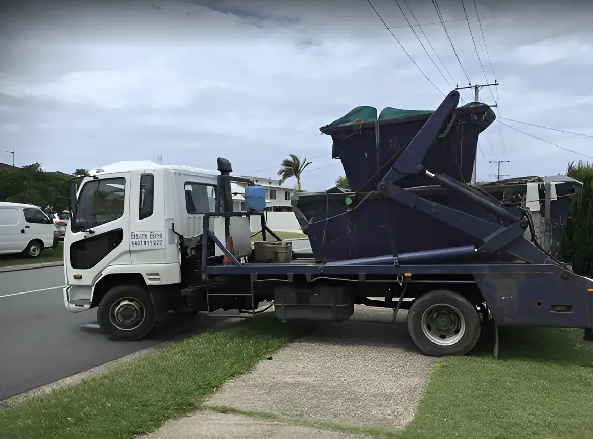 White and Blue Roll-off Truck Parked on a Residential Street — Skip Bin Hire Sunshine Coast in Kin Kin, QLD