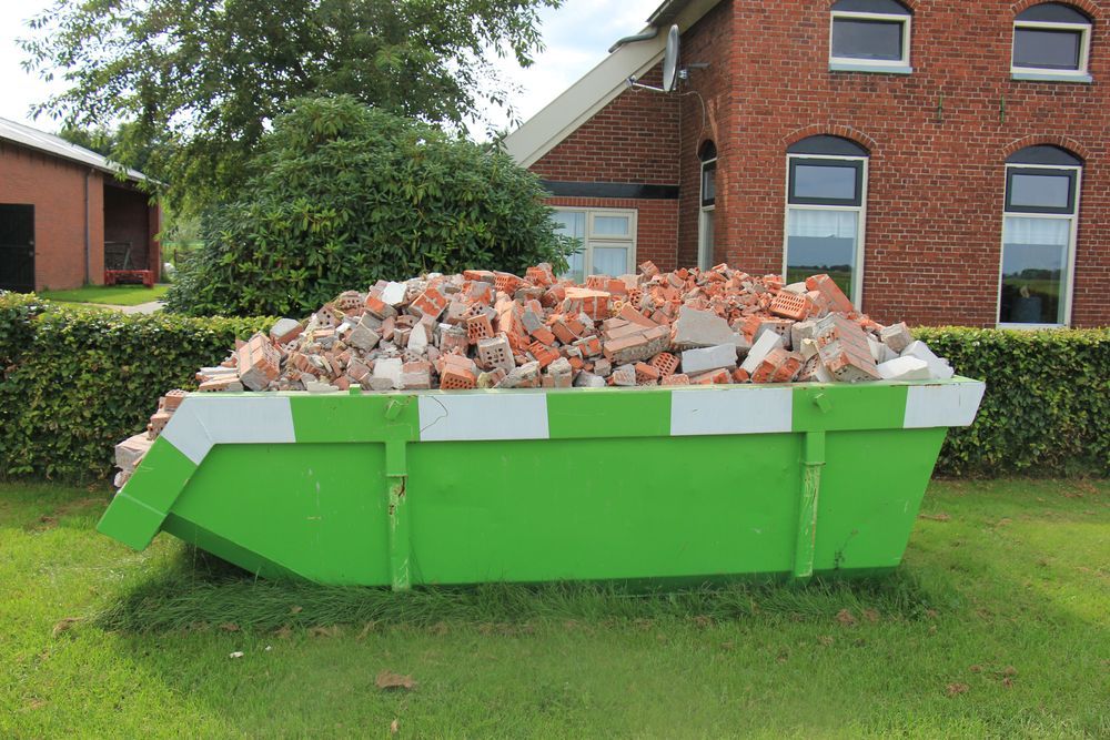 Green Dumpster Overflowing With Brick Rubble — Skip Bin Hire Sunshine Coast in Noosa, QLD
