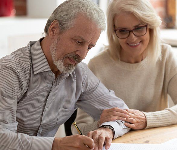 Old Couple Sign Legal Paper — Elkhart, IN — Maryellen Baker Attorney at Law
