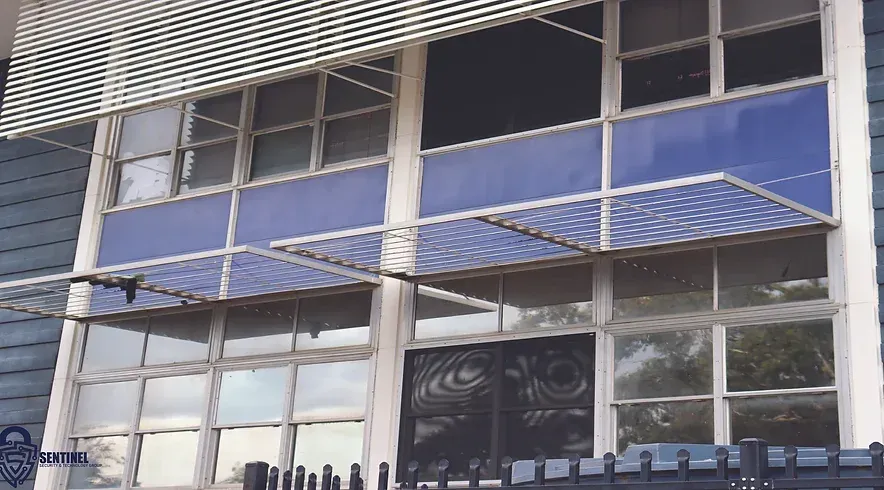 A blue and white building with a canopy over the windows