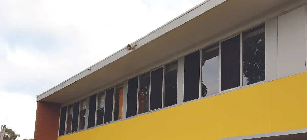 A yellow building with a lot of windows on it