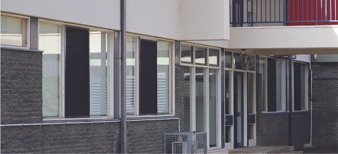A building with a red railing and a lot of windows