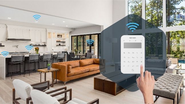 A person is using a smart phone to control a security system in a living room.