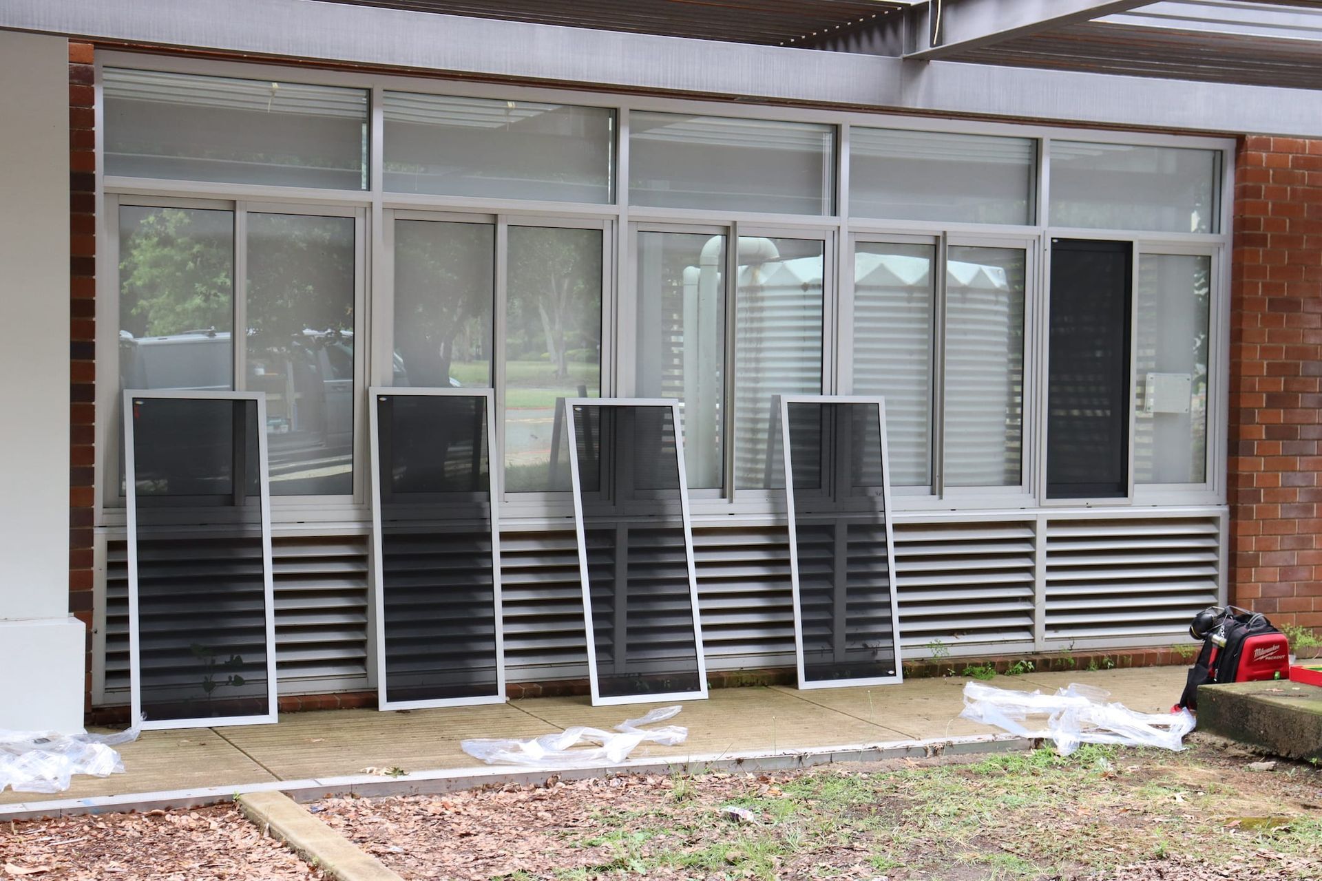 A row of screens are sitting outside of a building