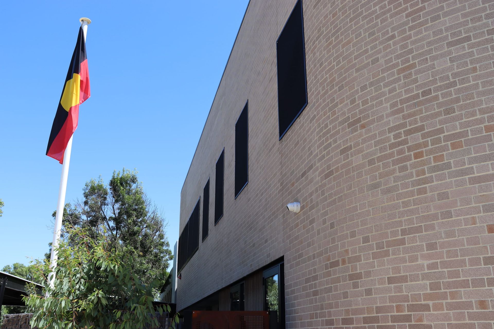 A german flag is flying in front of a brick building