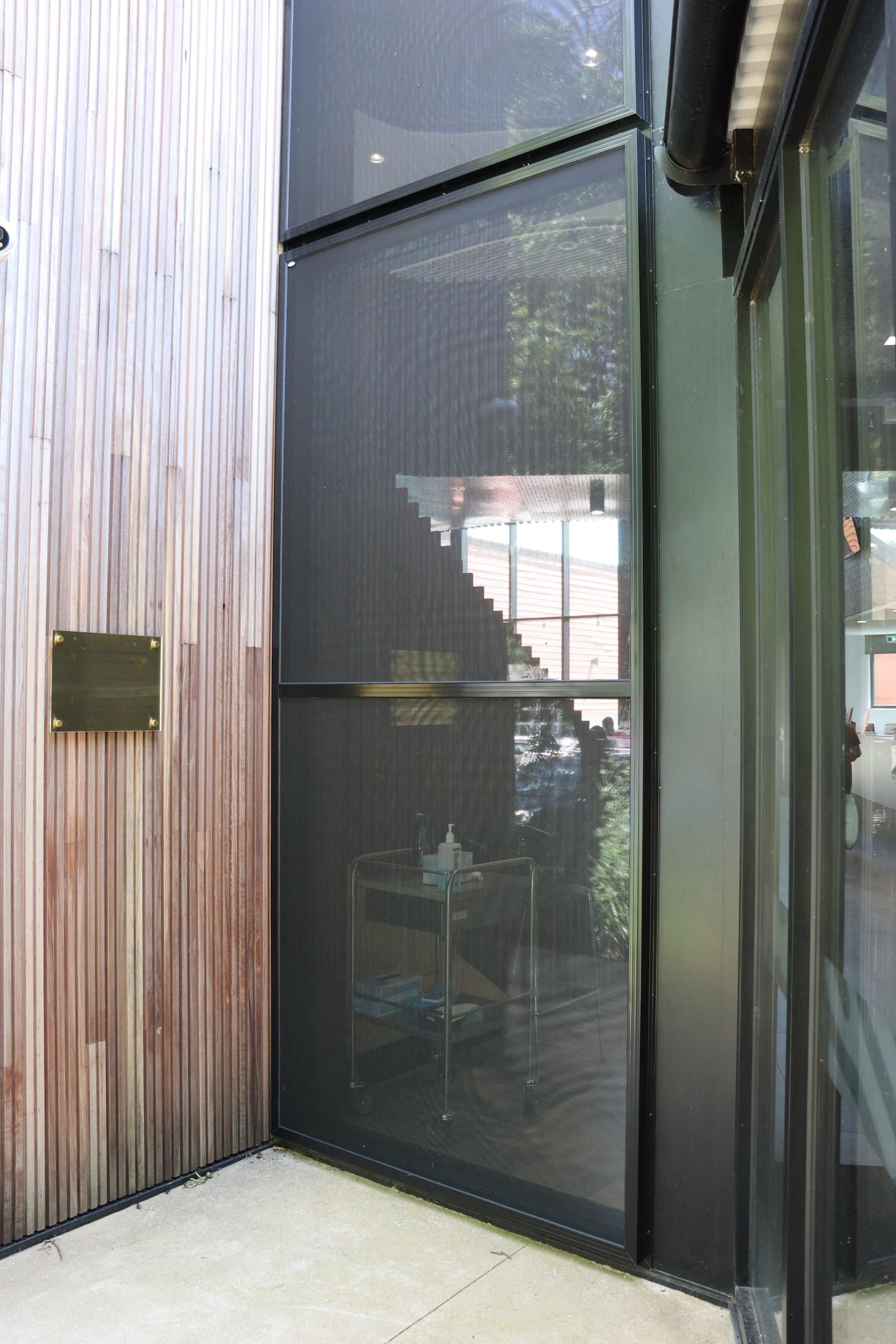 A building with a large window and a wooden wall.