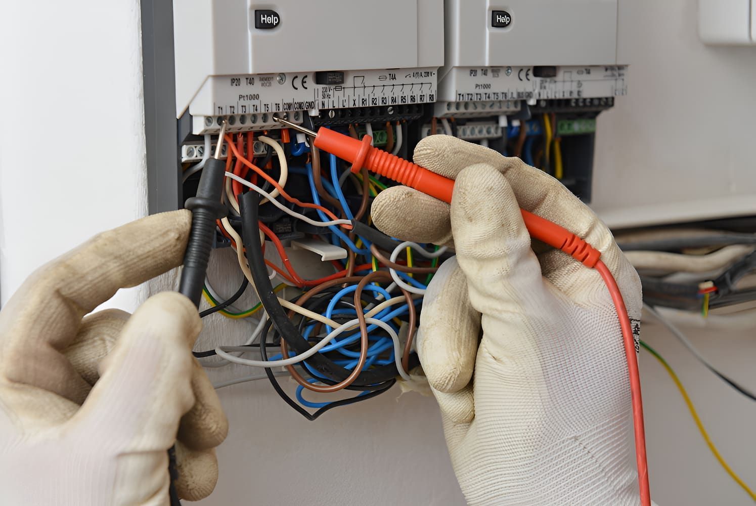A Person Is Using A Multimeter To Test A Bunch Of Wires — Chris Hickling Electrical In Port Macquarie, NSW
