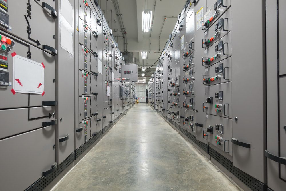A Long Hallway Filled With Lots Of Electrical Panels In A Building — Chris Hickling Electrical In Port Macquarie, NSW