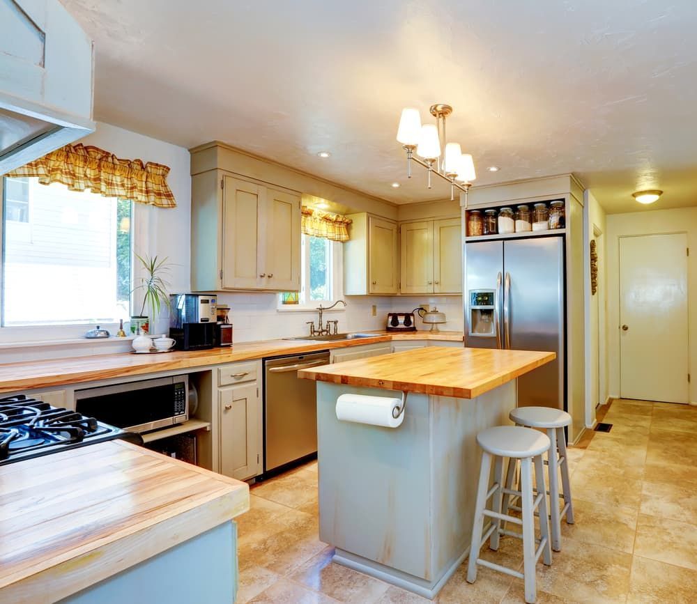 A Kitchen With Stainless Steel Appliances And Wooden Counter Tops  — Floorgard in Wamberal, NSW