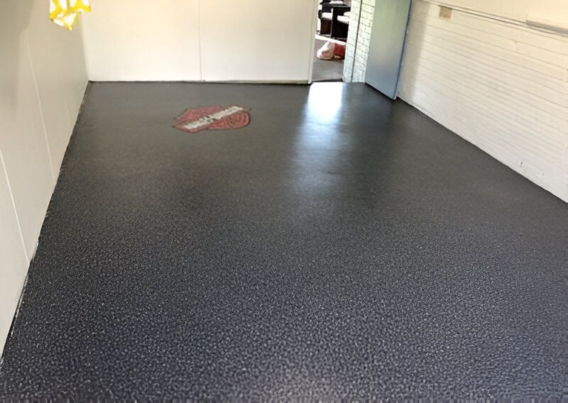A Garage Floor With A Stop Sign On It  — Floorgard in Wamberal, NSW